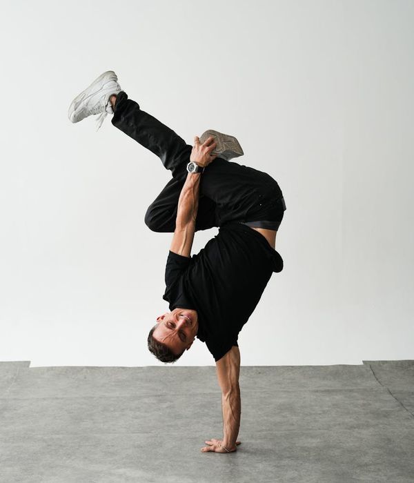 Man performing a dynamic strength exercise in a modern studio.
